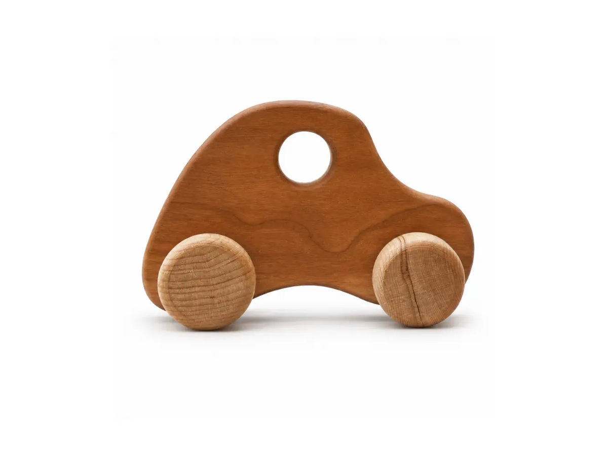 Larger wooden push car with cherry hardwood body and birch wheels on a white background.