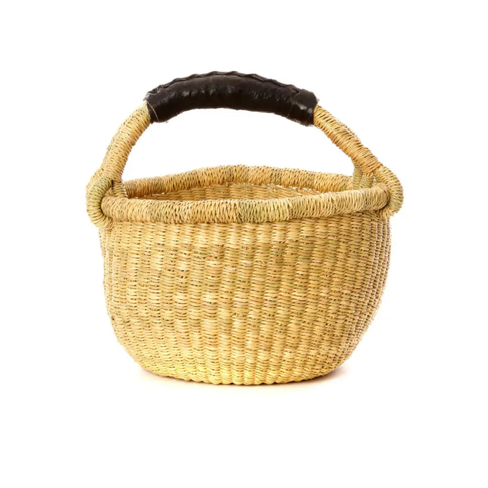 Woven basket with a black handle on a white background