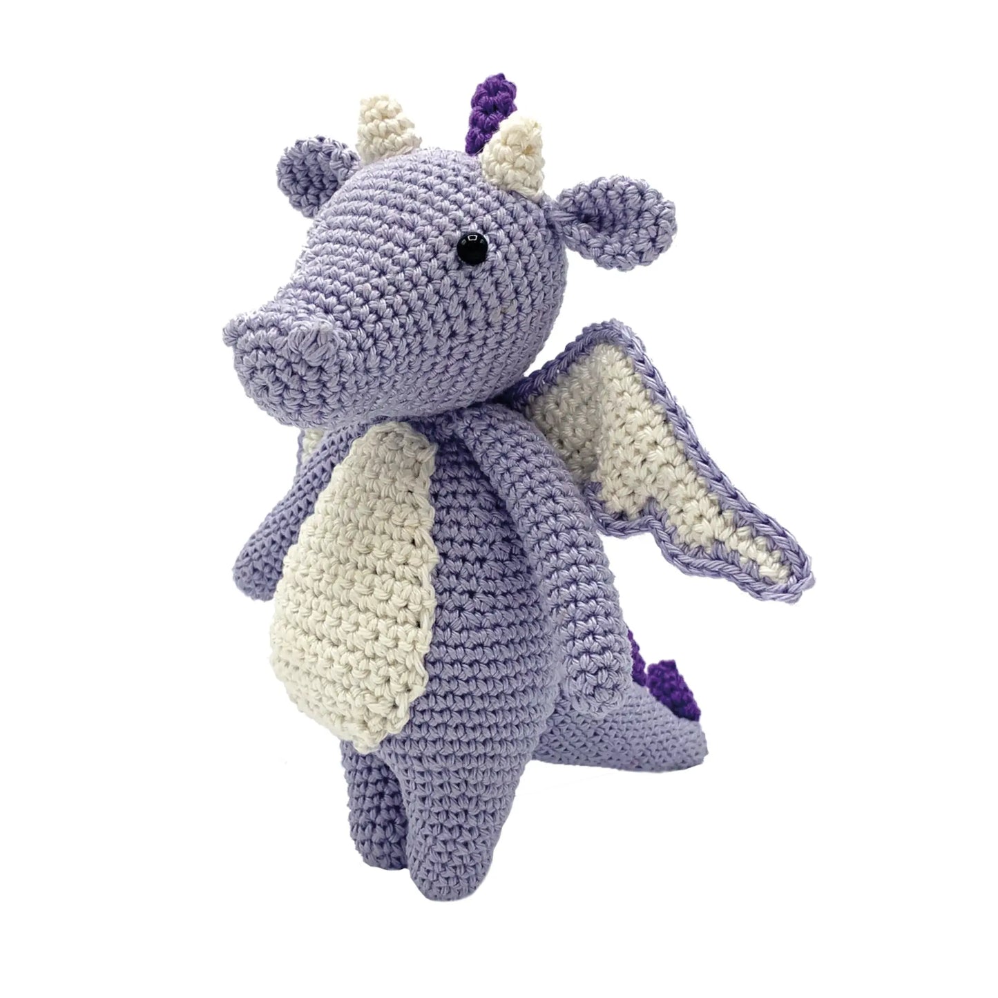 Finished lilac dragon stuffed animal from a crochet kit on white background
