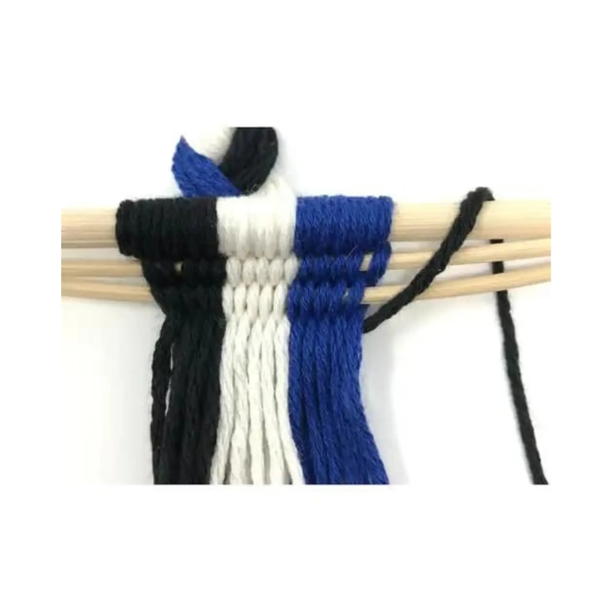 Blue, white, and black loomless weaving project in progress on wooden sticks