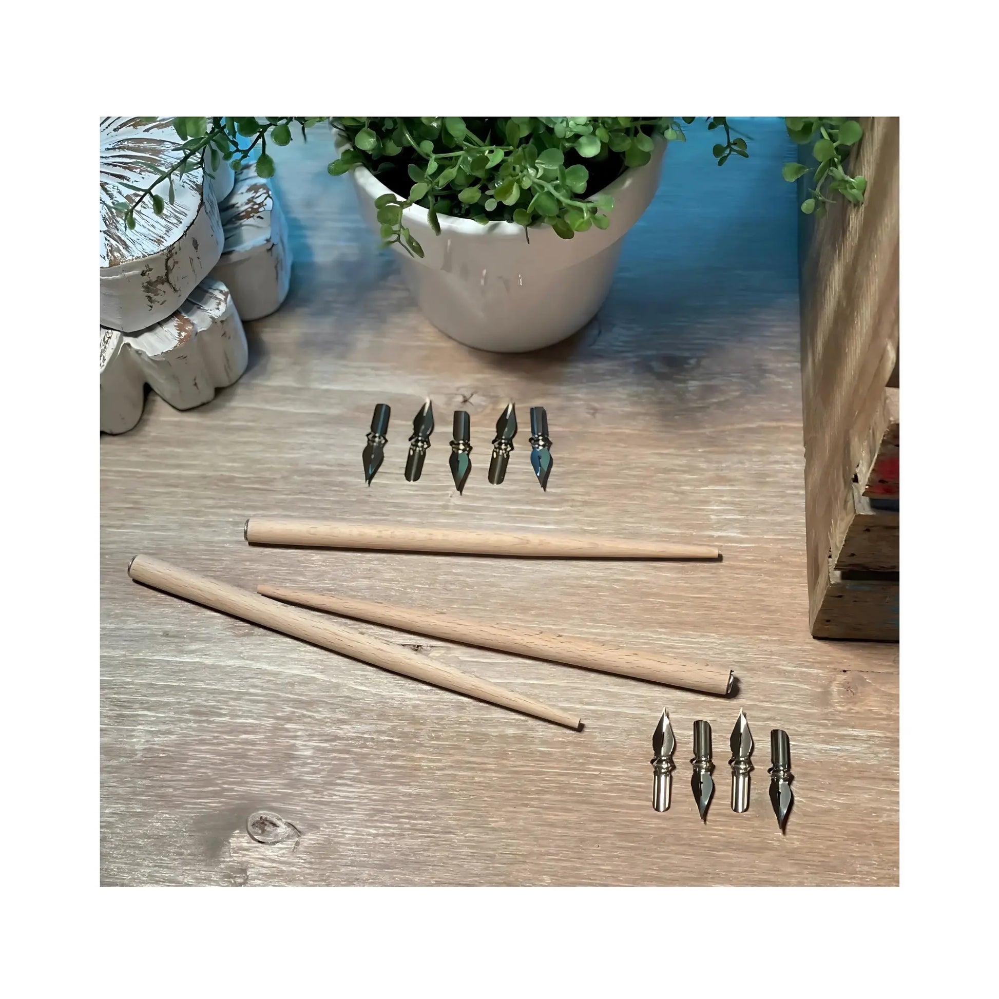 wooden dip pen holders and nibs arranged for calligraphy and ink work