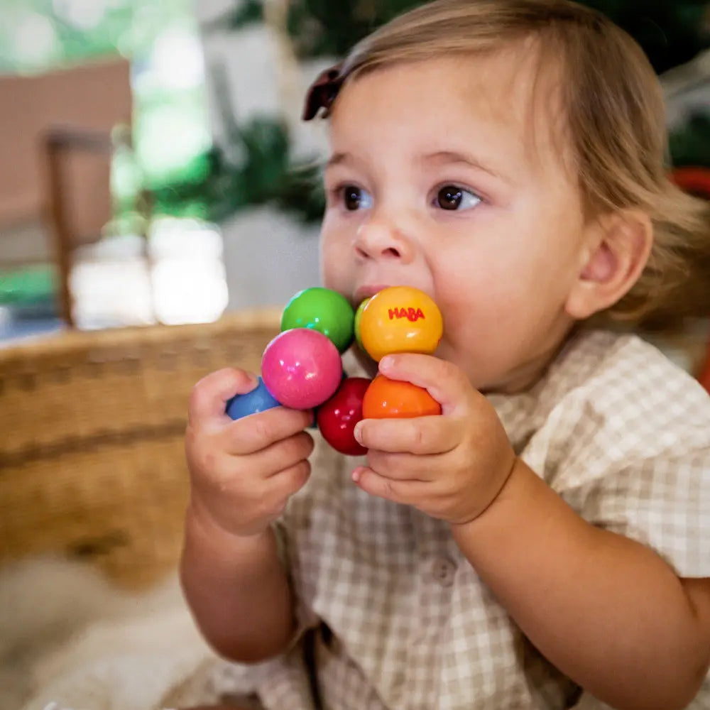 Child holding and playing with a colorful toy