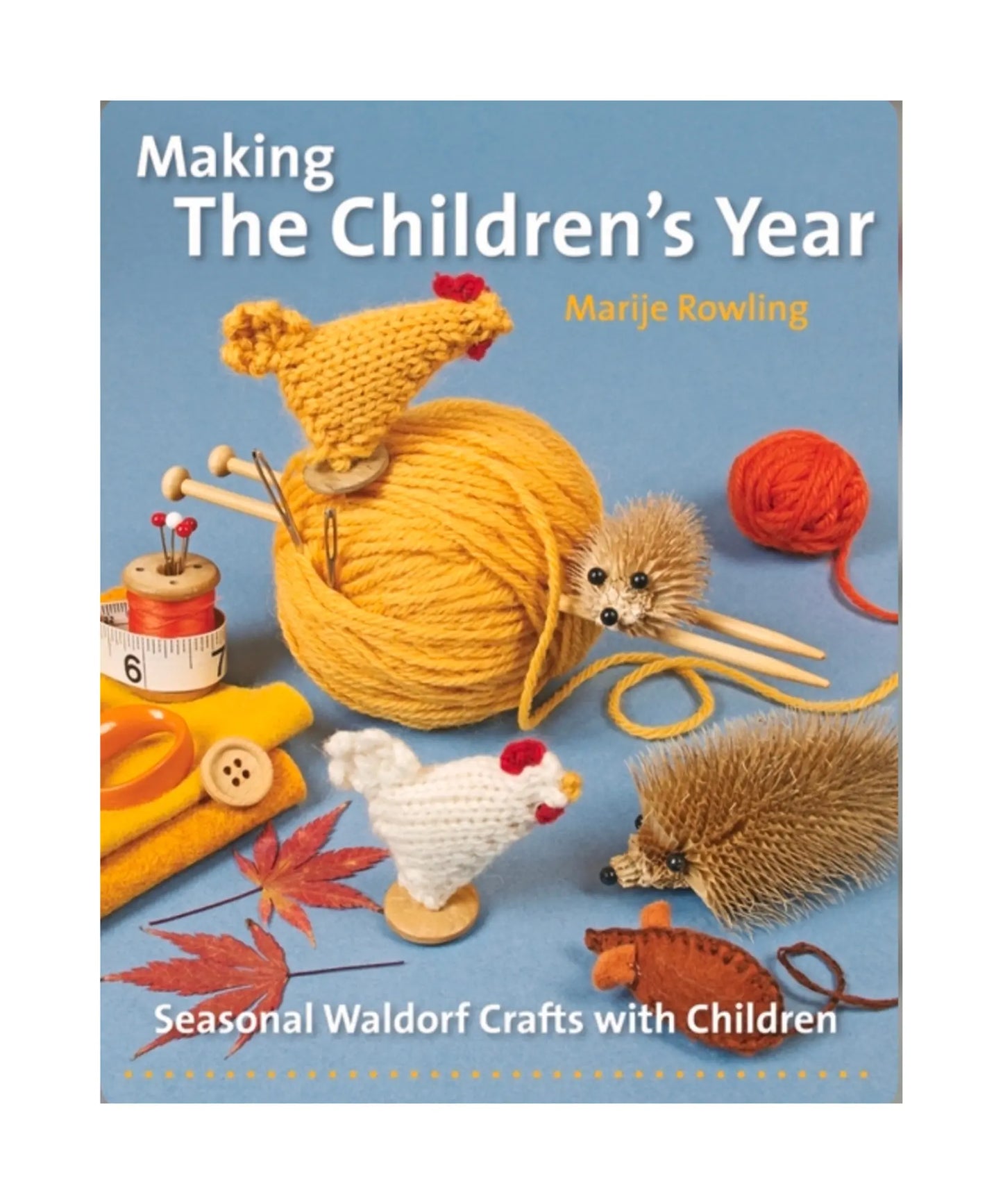 Book cover of 'Making The Children's Year' with yarn and craft items on a blue background