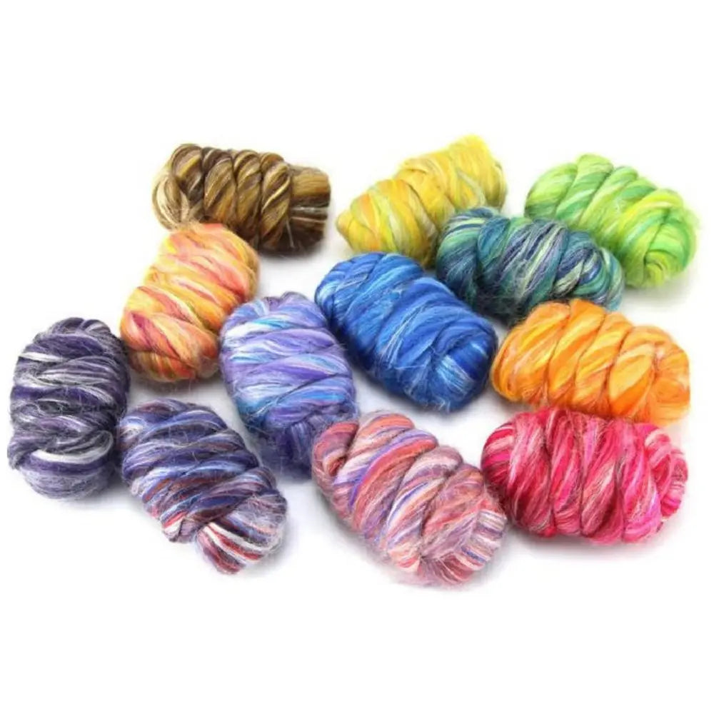 Assorted colorful skeins of merino and silk wool on a white background