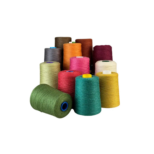Assorted colorful spools of thread on a white background
