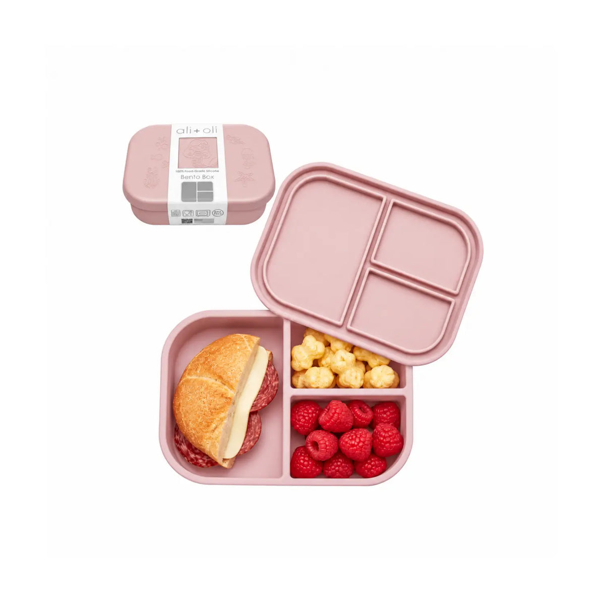 Ali+Oli Mermaid silicone bento box with three compartments filled with sandwich, raspberries, and snacks.