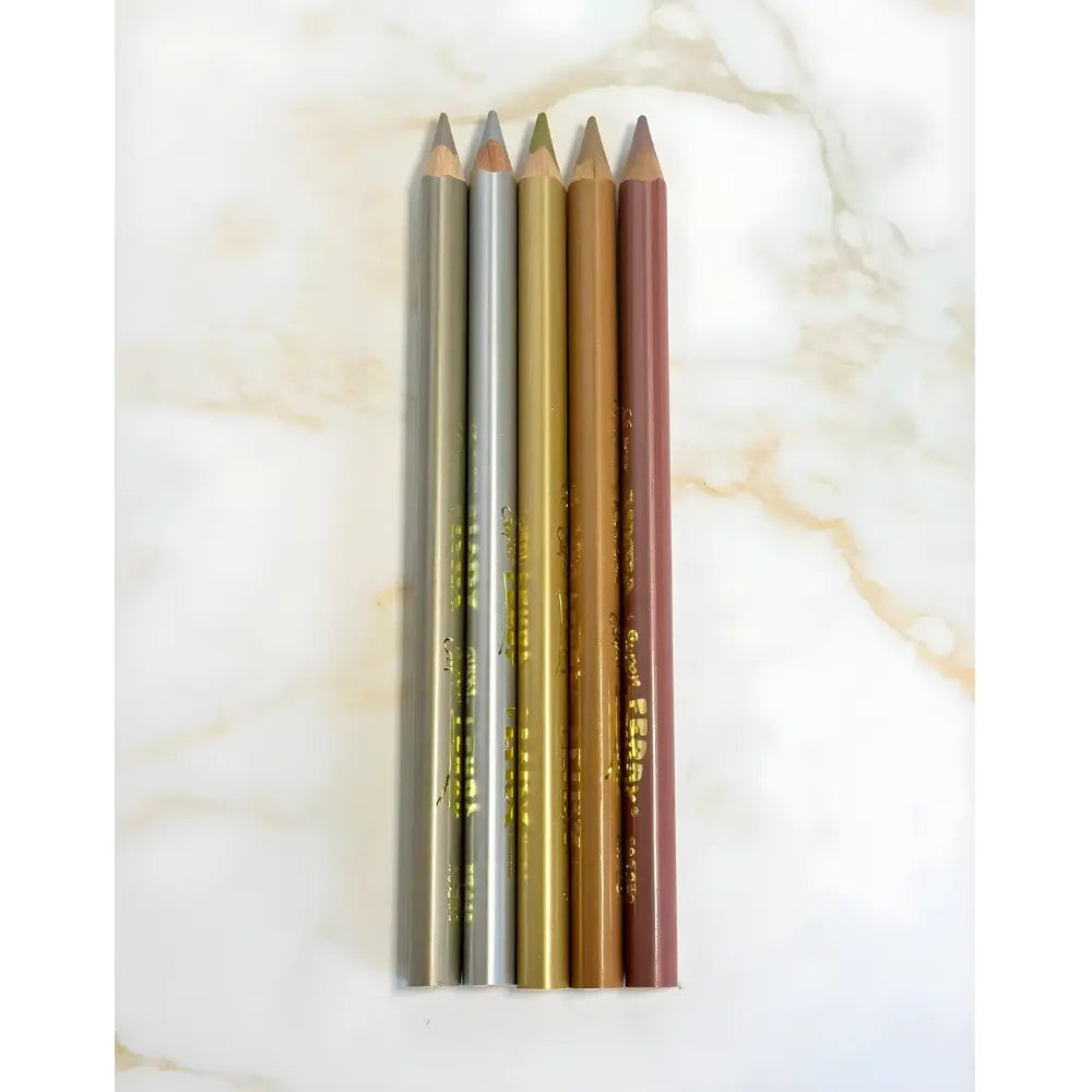 Set of four makeup pencils in different colors on a marble background