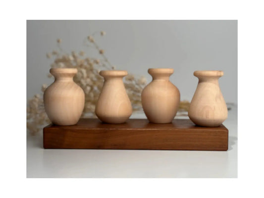 Set of four wooden vases on a wooden stand with a neutral background