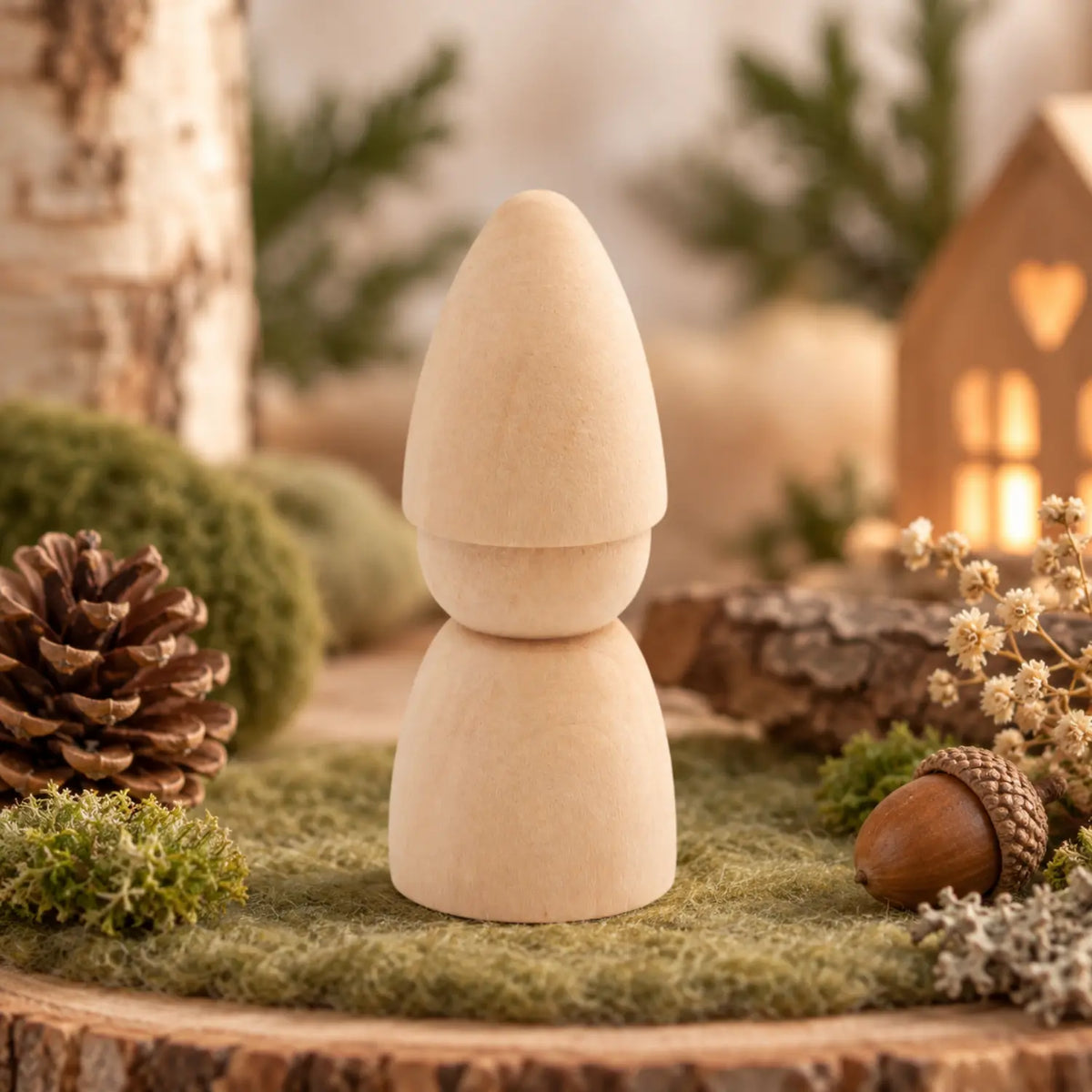 Unfinished birch wood gnome craft figure with on mossy table woodland scene