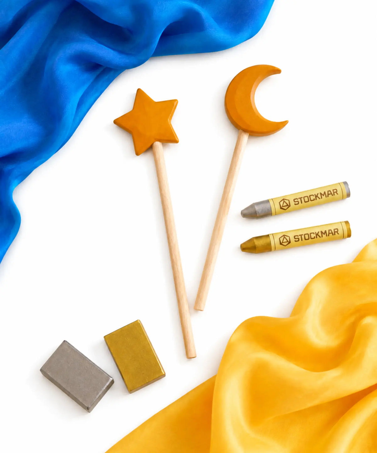 A  moon and star wooden wand set, gold and silver Stockmar crayon set, and a blue and gold mini silk