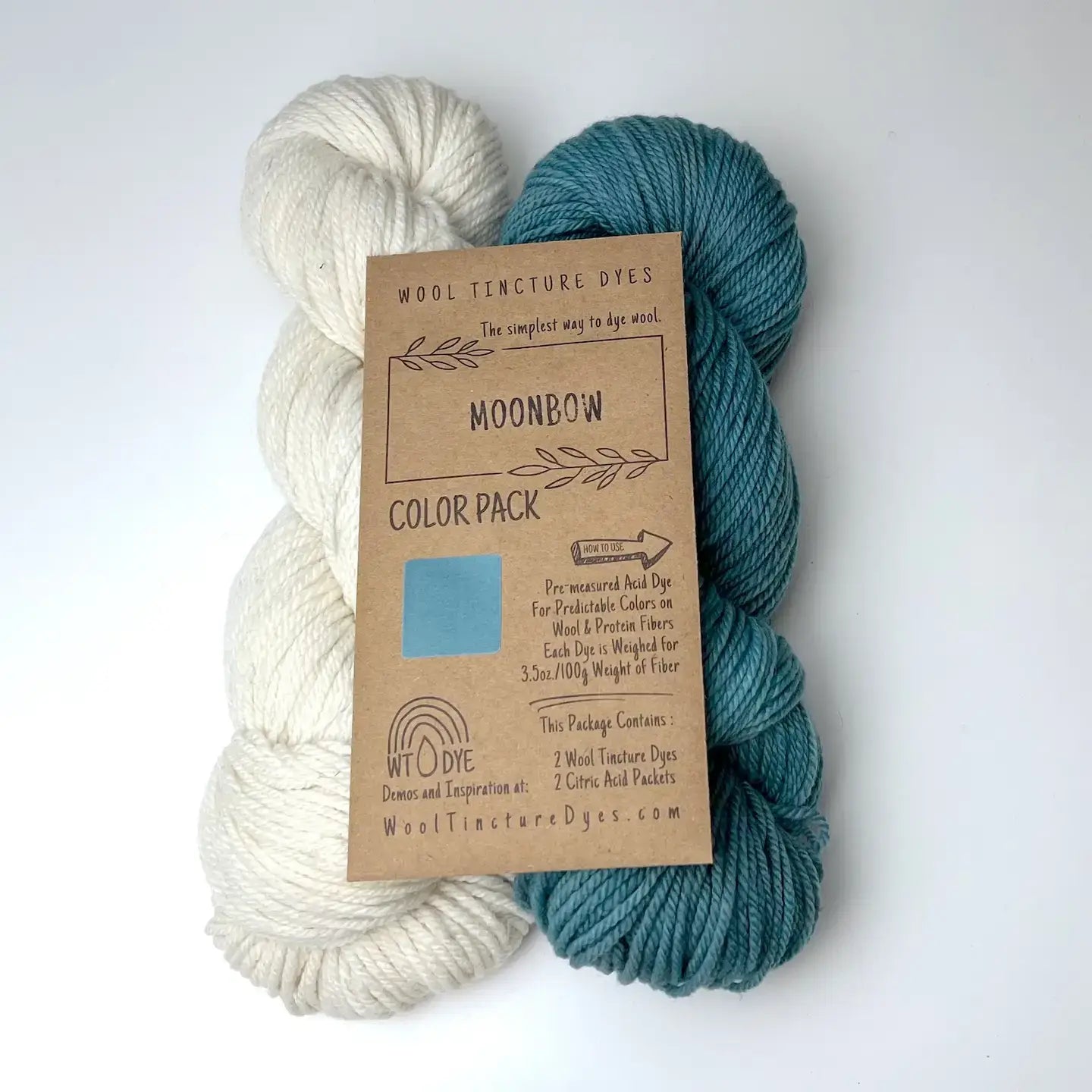 Moonbow Wool Tincture tea bag dye color pack with undyed yarn and soft blue sample color.