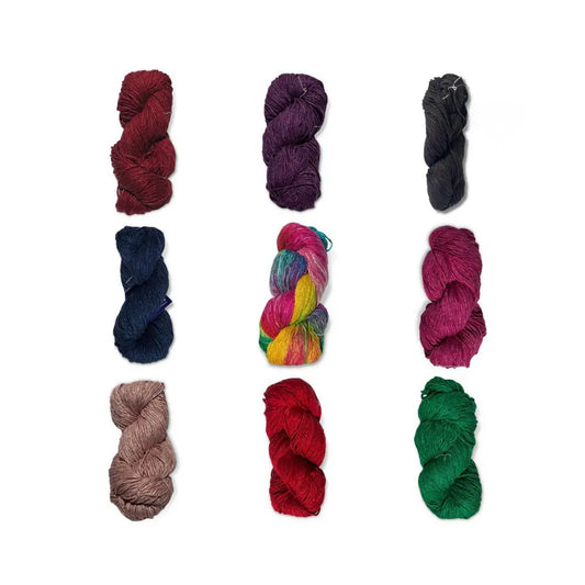 Assorted skeins of mulberry silk yarn in various colors on a white background