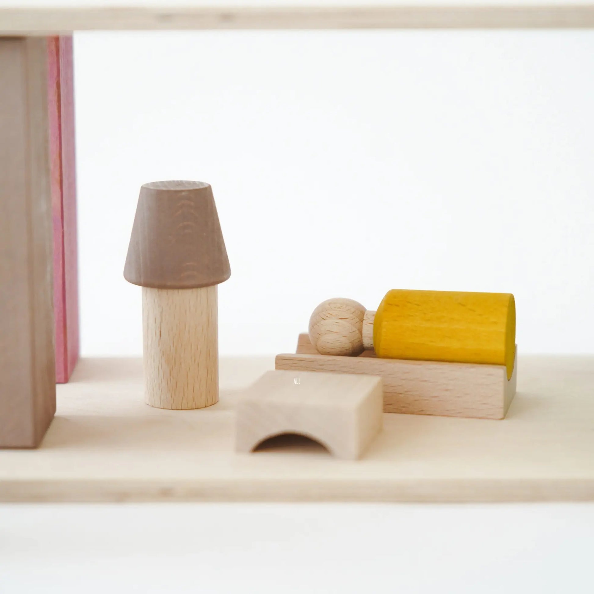 Set of wooden toys on a light surface with a white background