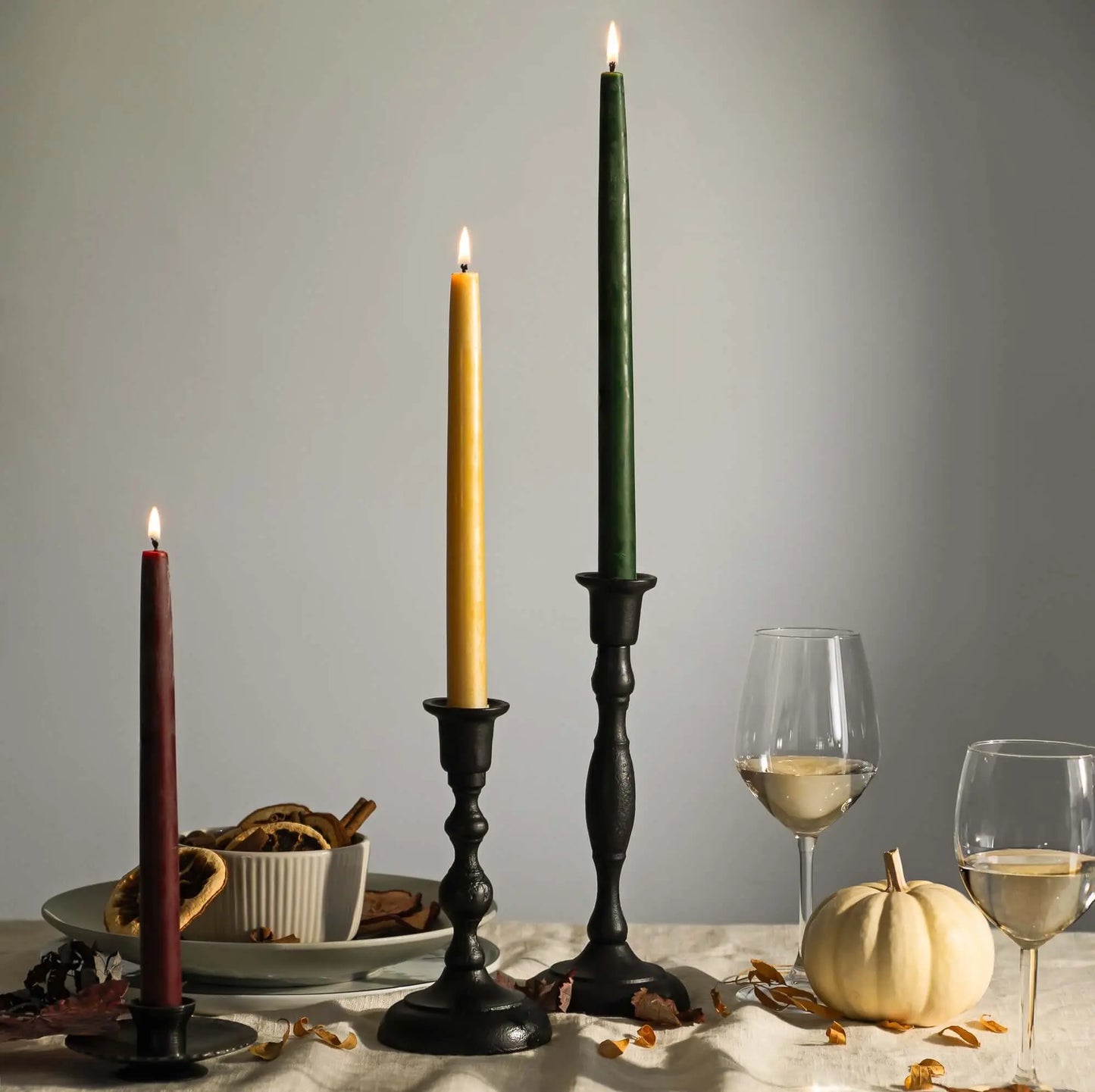 beeswax taper candles in iron candle holders