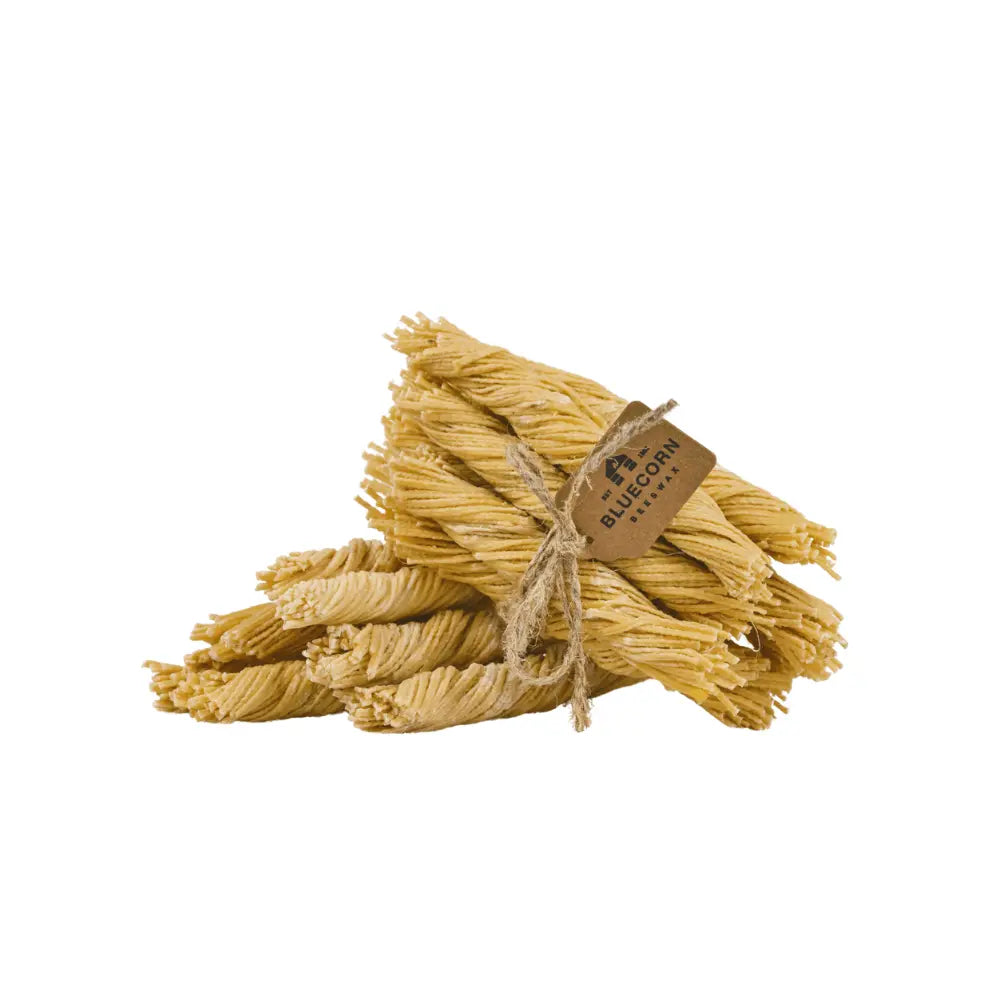 Bunch of beeswax wick firestarters with a tag on a white background