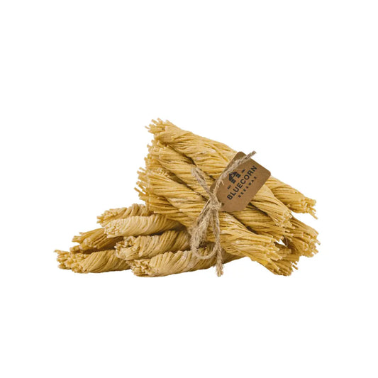 Bunch of beeswax wick firestarters with a tag on a white background