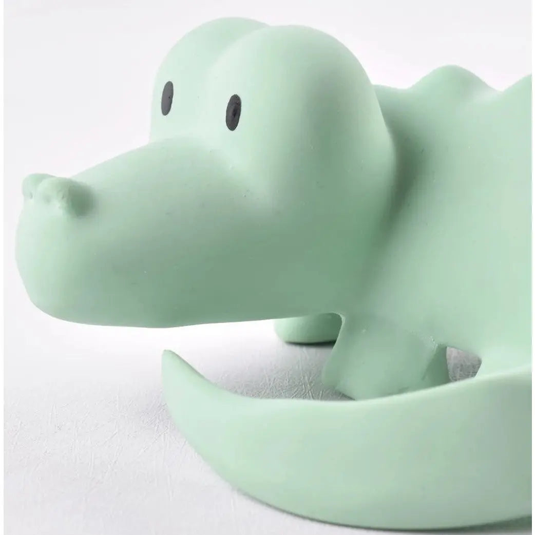 Natural rubber crocodile baby toy angled side view showing shape and texture for infant play