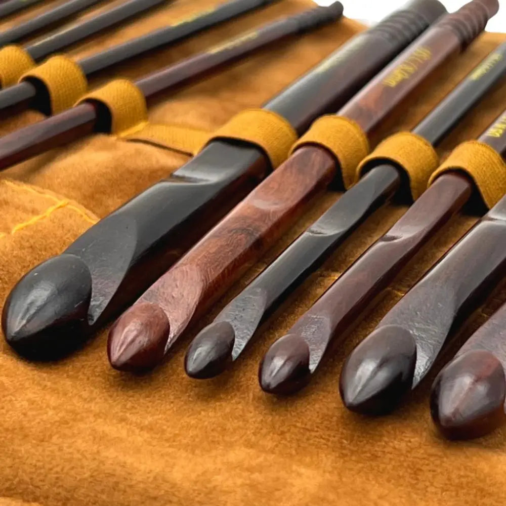 Set of chisels with wooden handles on a brown leather case