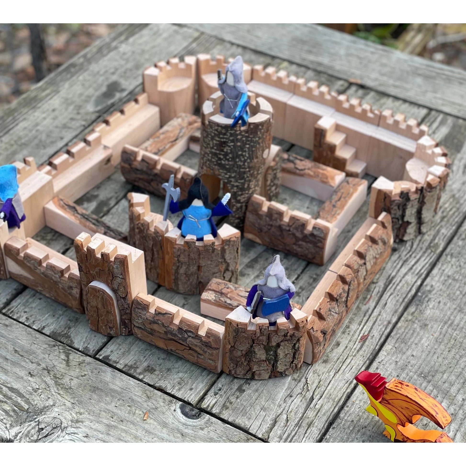 Overhead view of a wooden castle building set with towers, walls, and central keep