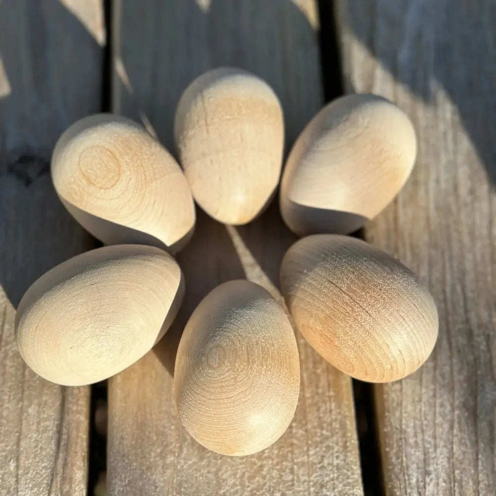 Wooden eggs on a wooden surface