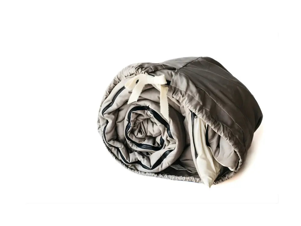 rolled natural sleeping bag with a white border on a white background