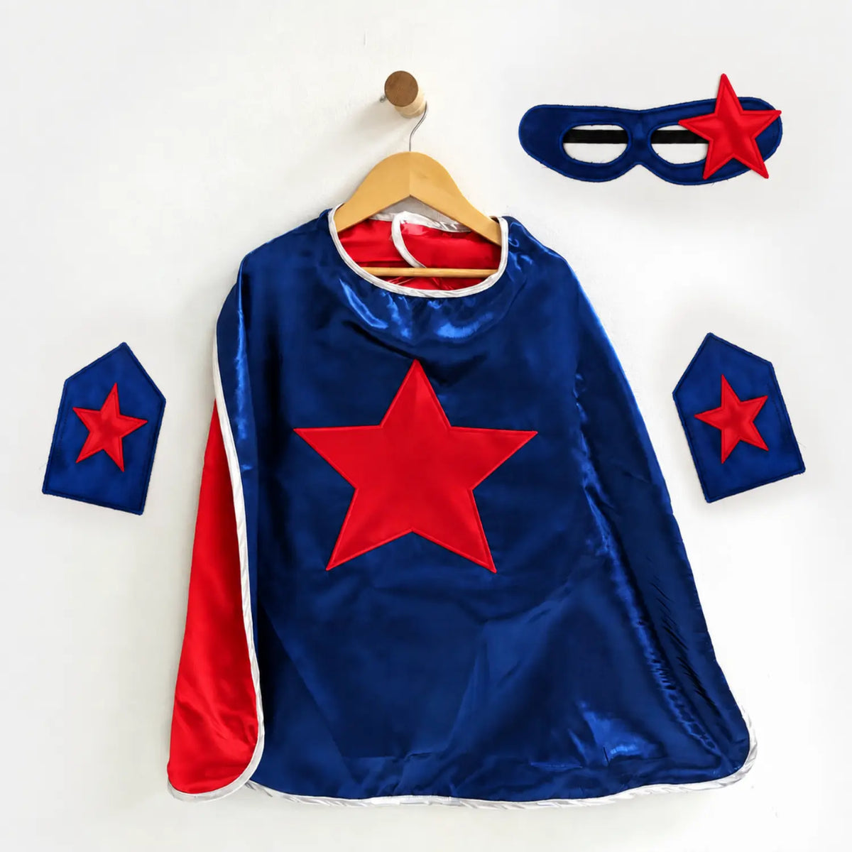 Navy blue superhero cape set with red star emblem, matching eye mask, and wrist cuffs.