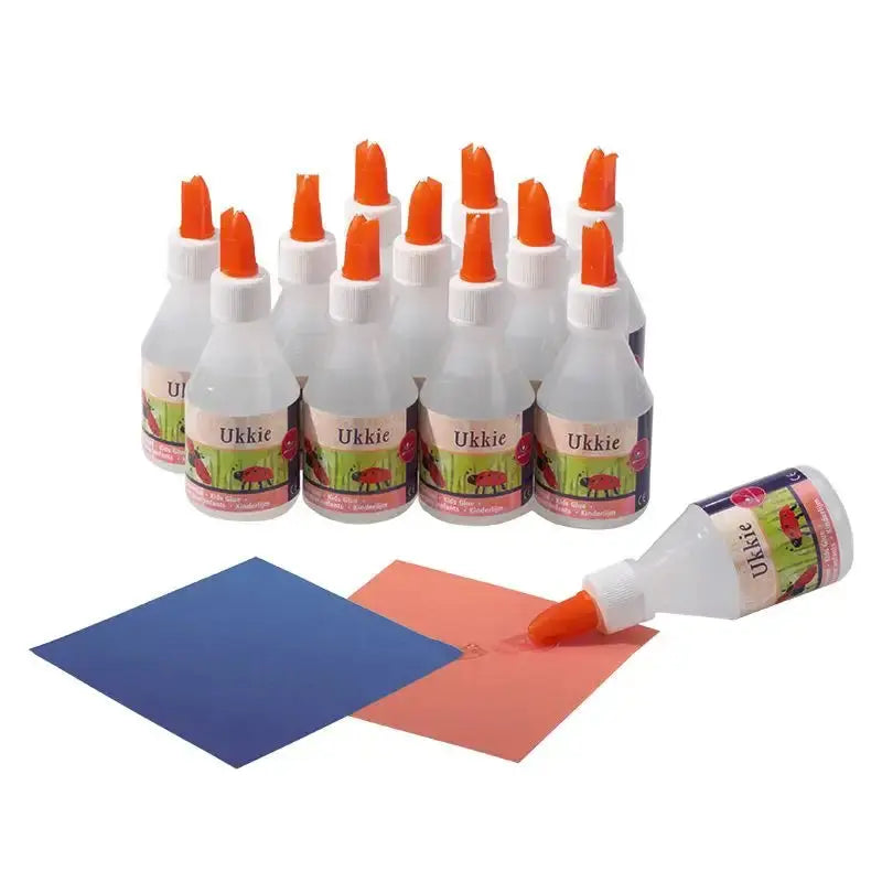 multiple bottles of ukkie kids craft glue with construction paper on white background
