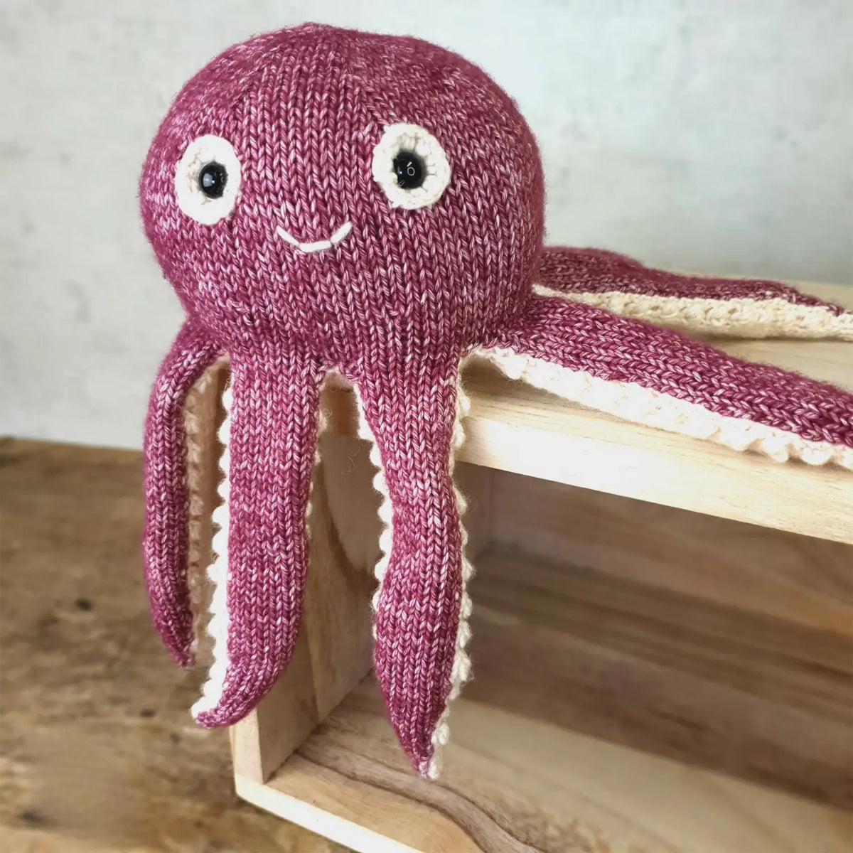 Olivia Octopus finished knitted toy with long berry and cream tentacles