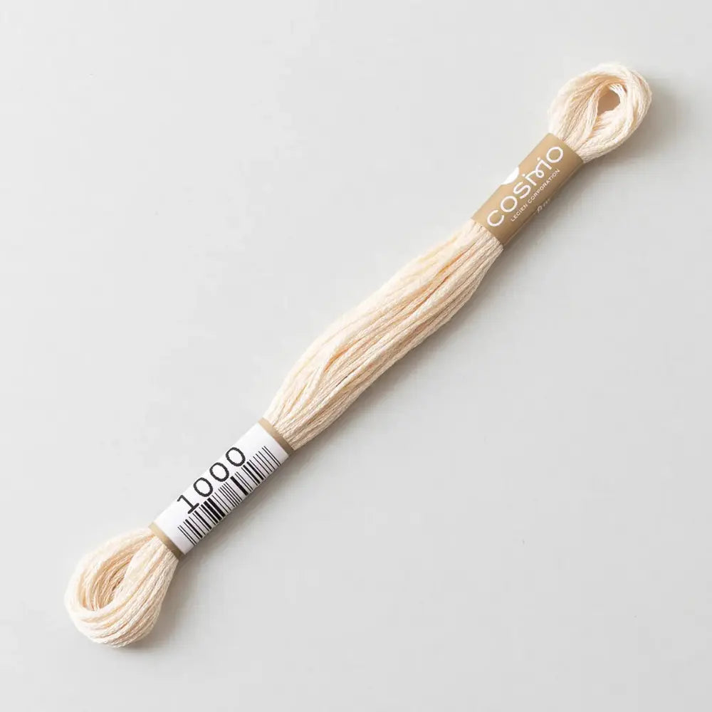 Off white cotton embroidery floss and 'Cosmo' branding on a light gray background