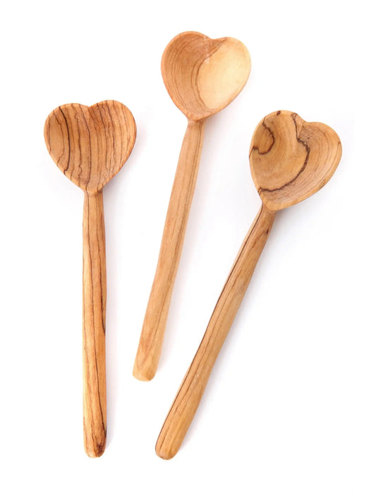 Hand-carved olive wood heart spoons showing natural grain variation and unique wood patterns