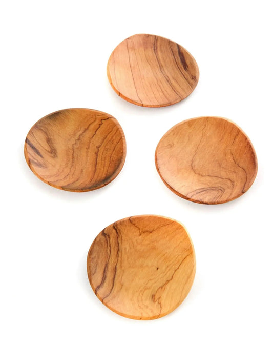 Four wooden plates with a natural finish on a white background