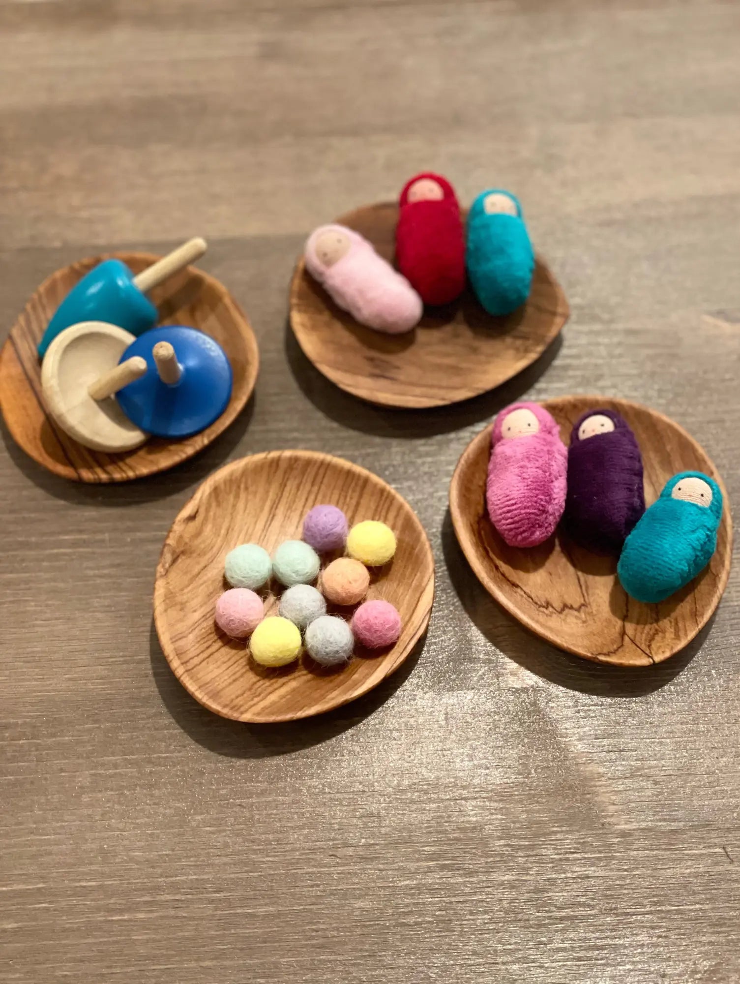 Colorful toys on wooden plates on a wooden surface