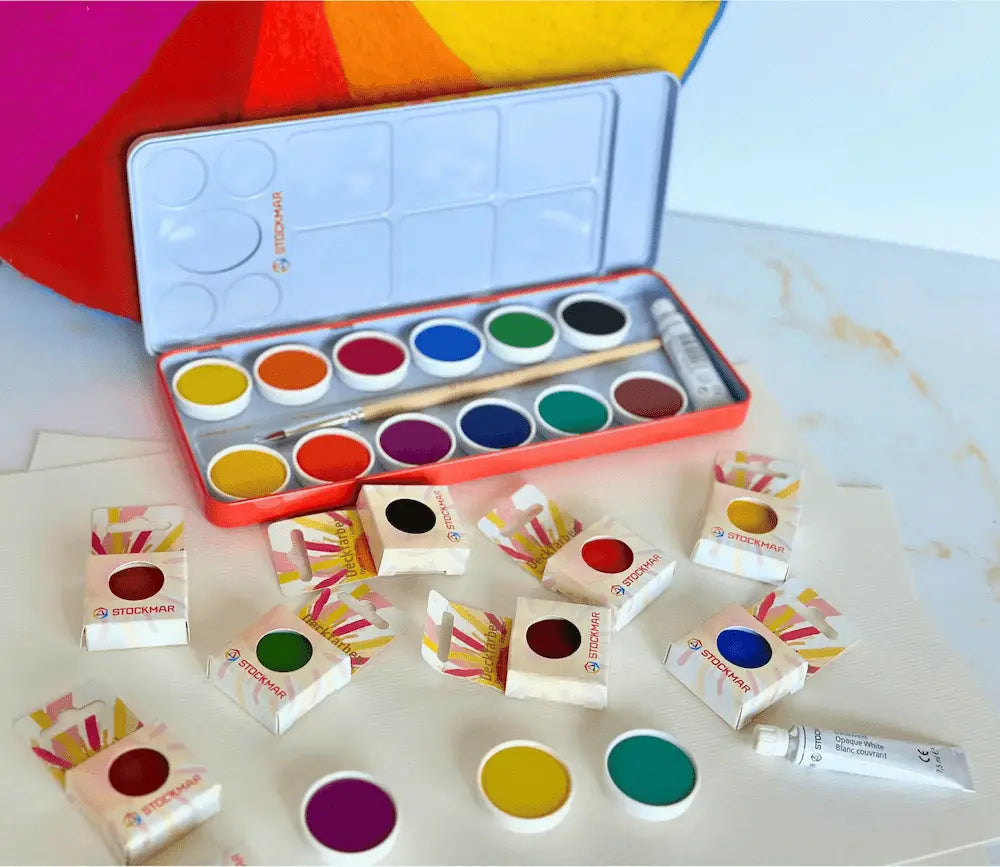 Opaque watercolor paint set with 12 colors displayed with felt color wheel and refill paint cakes for color mixing and Waldorf art use