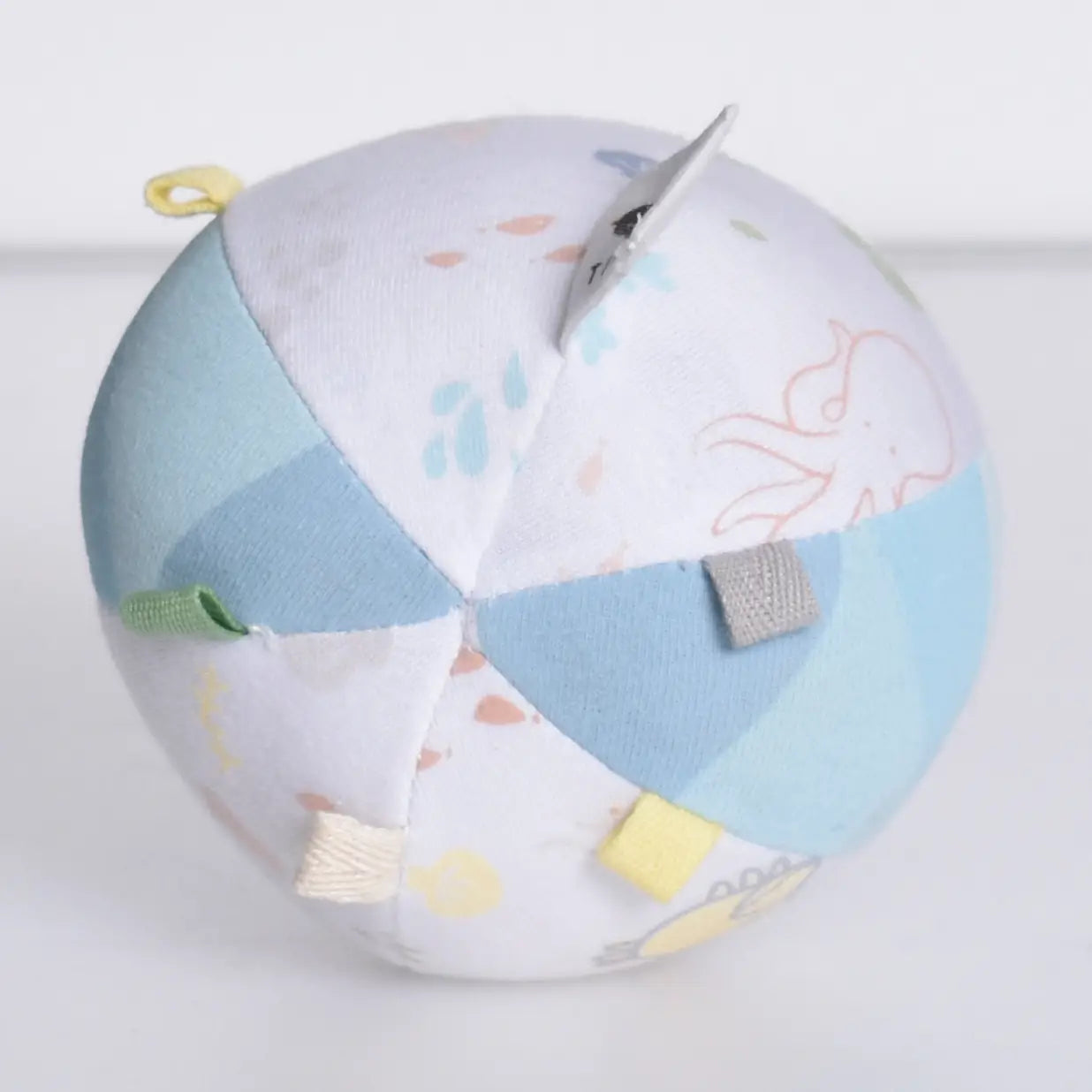Organic cotton baby activity ball rattle bottom view showing rounded shape and soft construction
