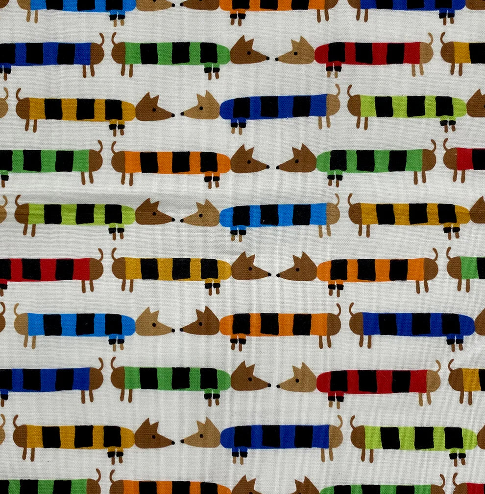 Close-up of colorful striped dachshund print on an organic cotton baby crinkle toy.