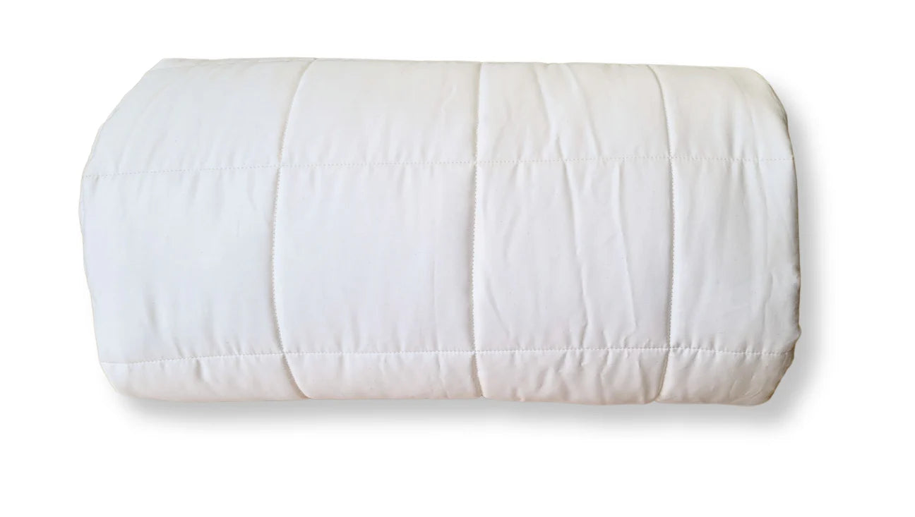 Rolled organic cotton comforter showing spiral layers and soft cotton fill