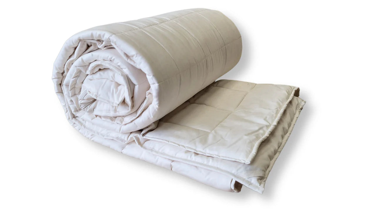 Rolled organic cotton comforter showing spiral layers and soft cotton fill