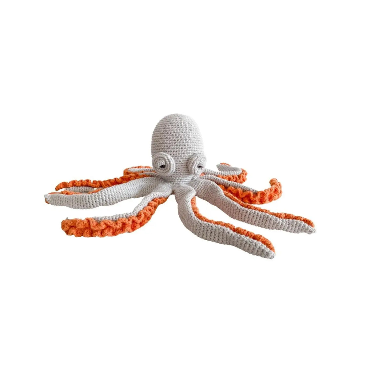 Light gray organic cotton crochet octopus soft toy with spiral eyes and eight long arms edged in bright orange ruffles