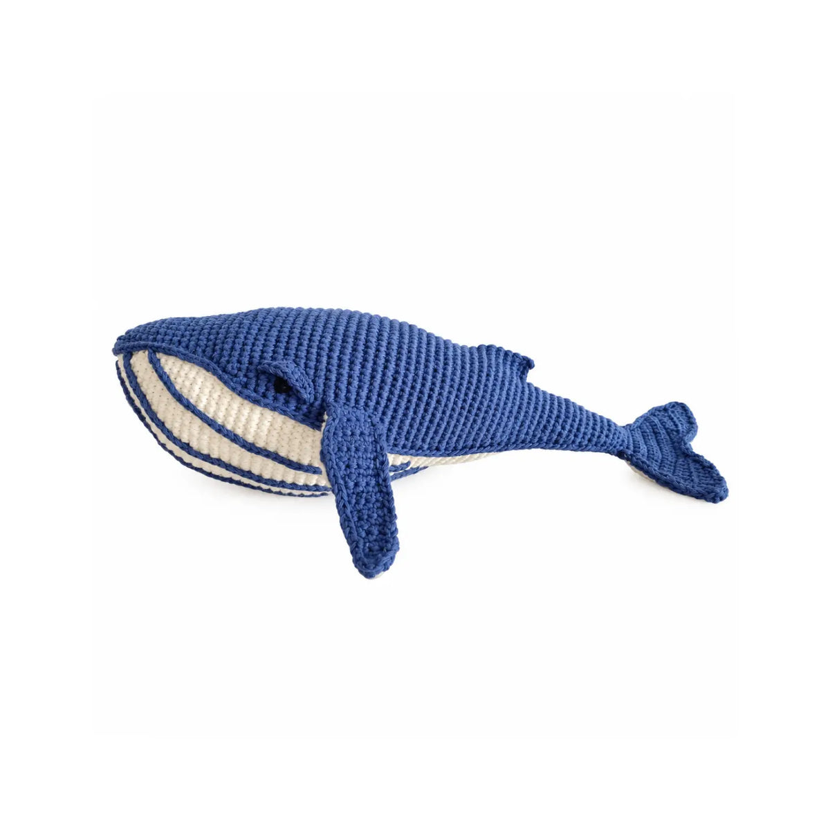 Deep blue organic cotton crochet whale soft toy with a cream striped belly and long flippers, shown from the side