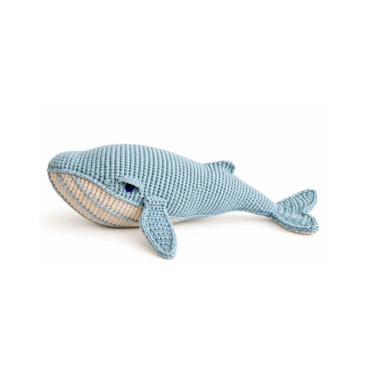 Misty blue organic cotton crochet whale soft toy with a cream striped belly and long flippers, shown from the side