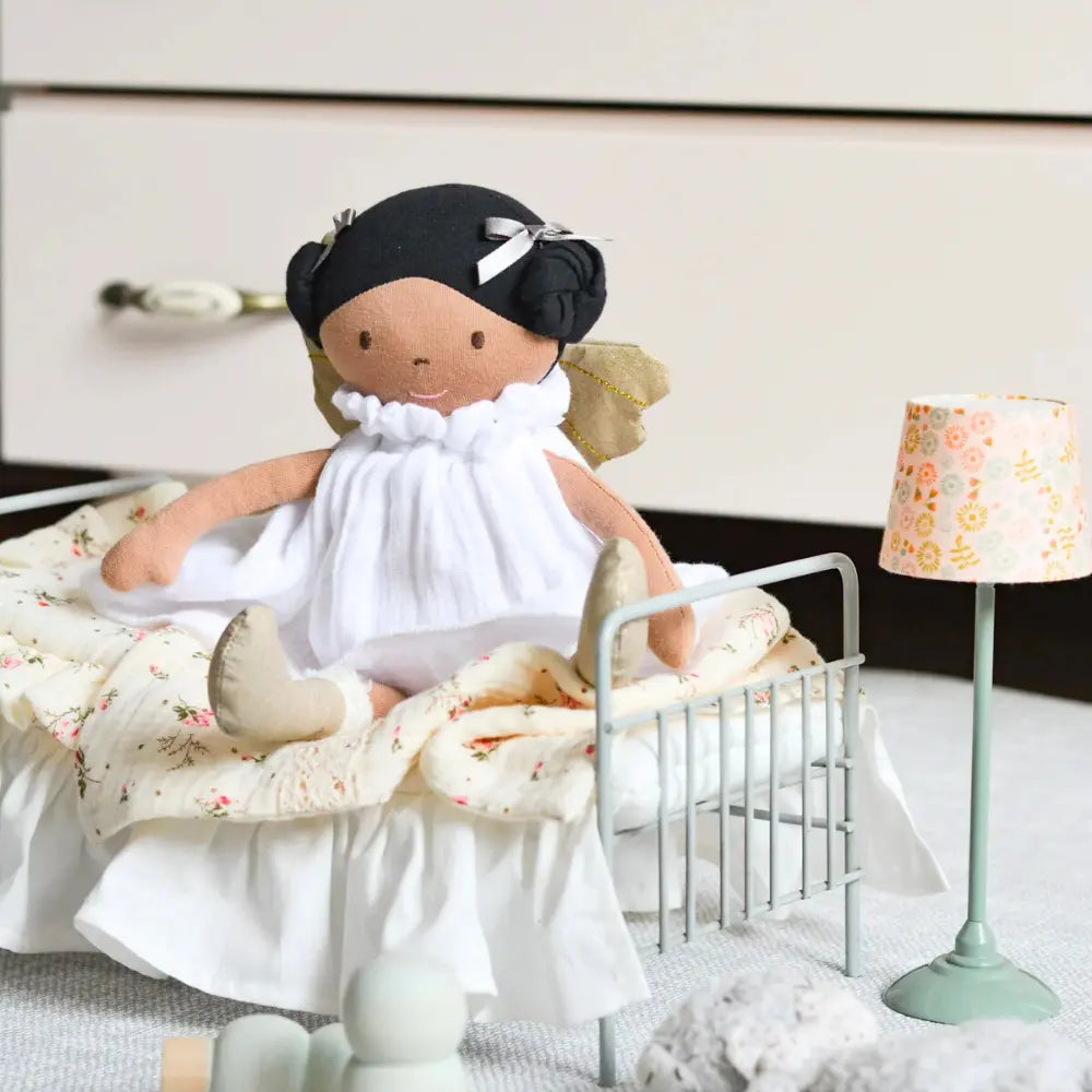 Organic cotton fairy doll seated at tea party table in child’s room during imaginative play
