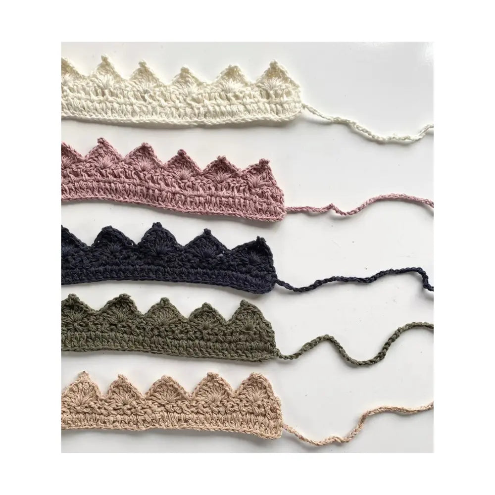 Set of crocheted trim in various colors on a white background
