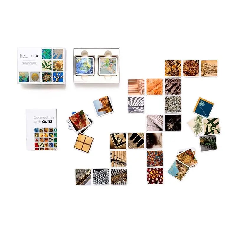 OuiSi visual connection game cards and instructions on wooden desktop