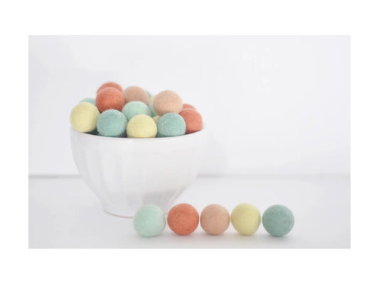 pastel felt wool balls in coral peach mint and yellow for garlands wreaths and seasonal craft decorations