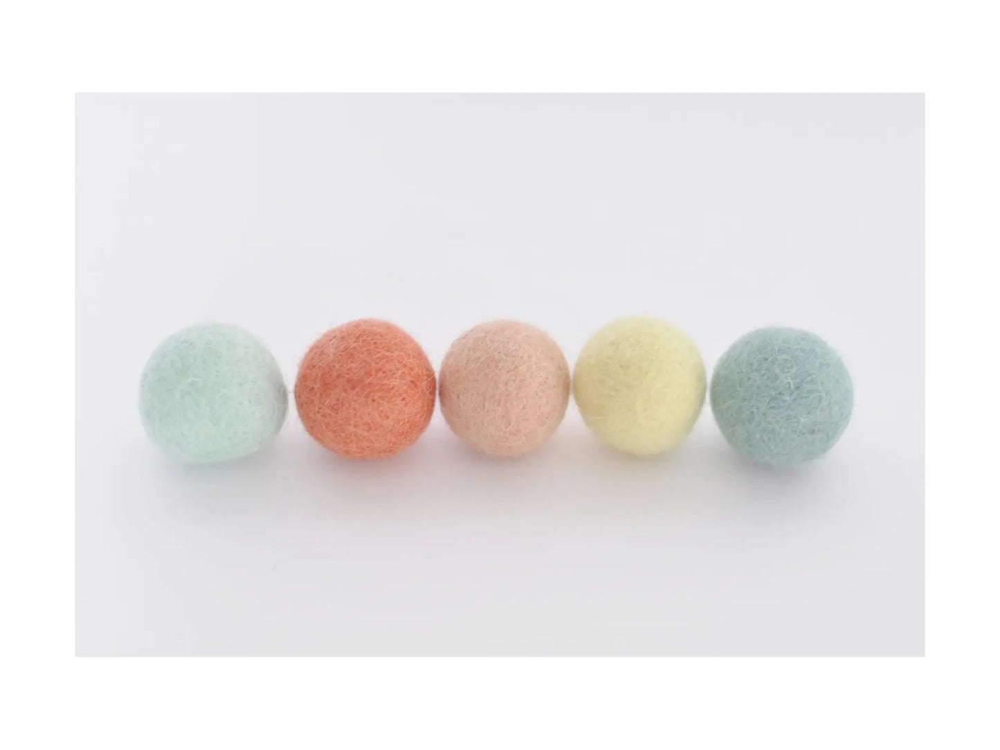 pastel felt wool balls in coral peach mint and yellow for garlands wreaths and seasonal craft decorations