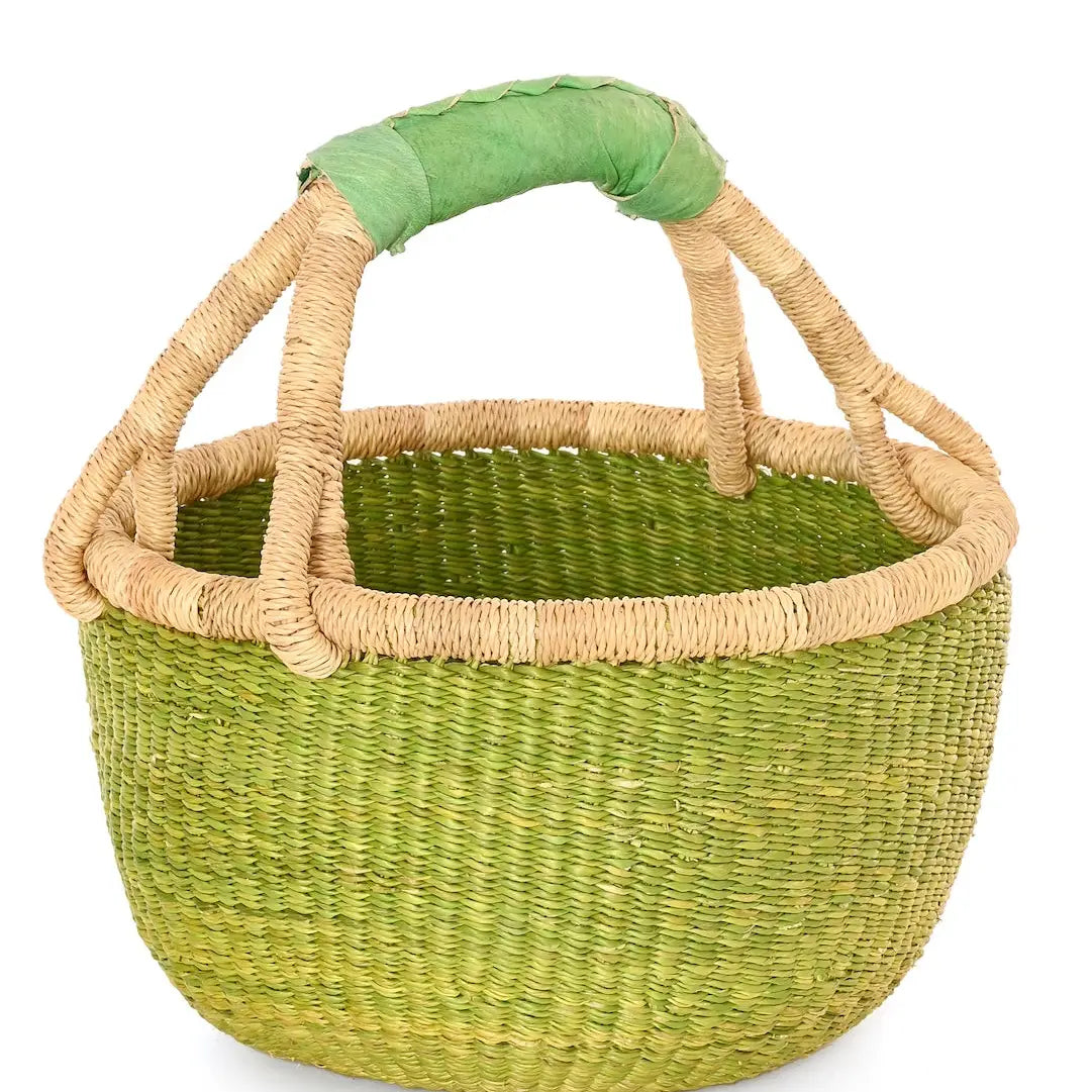 Green woven basket with beige handle on a white background