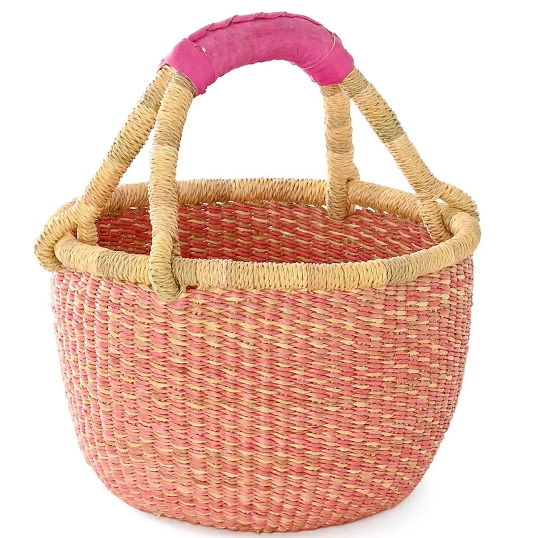 Woven basket with pink handle on a white background