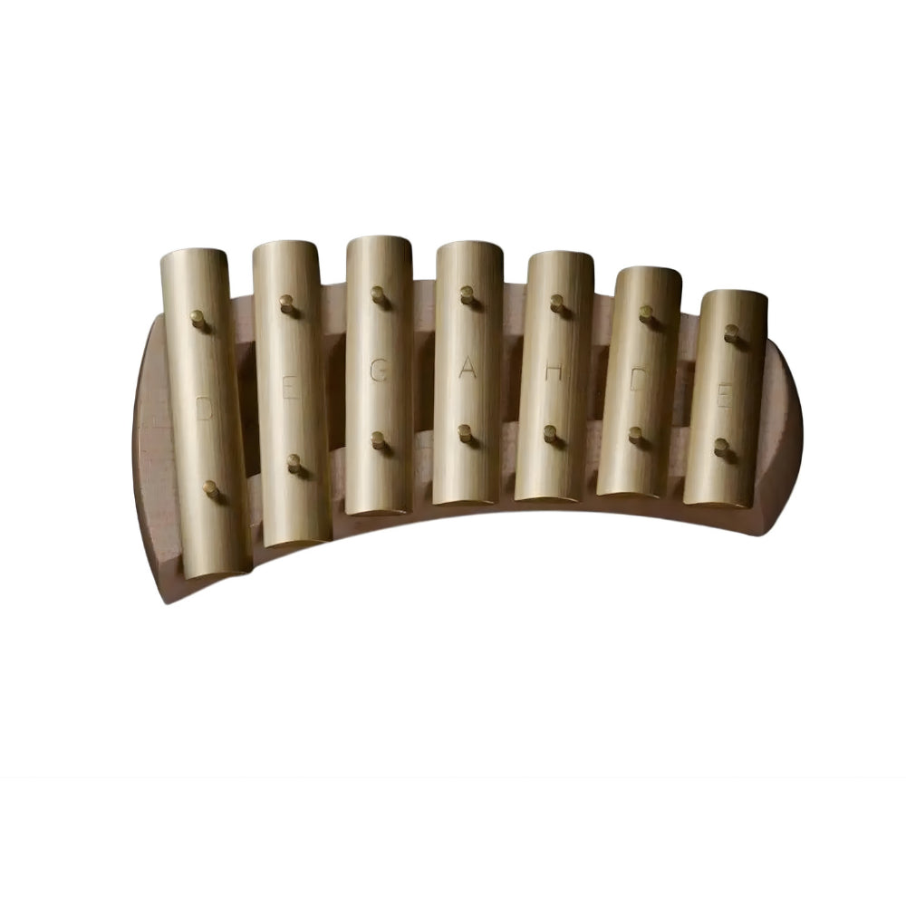 Wooden musical glockenspiel with brass bars on a white background