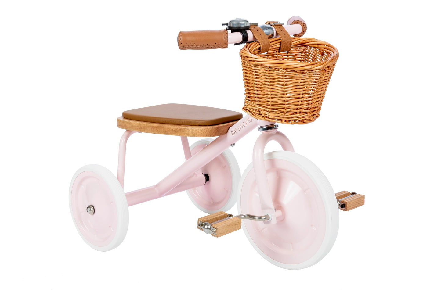 Pink tricycle with a wicker basket and wooden seat on a white background