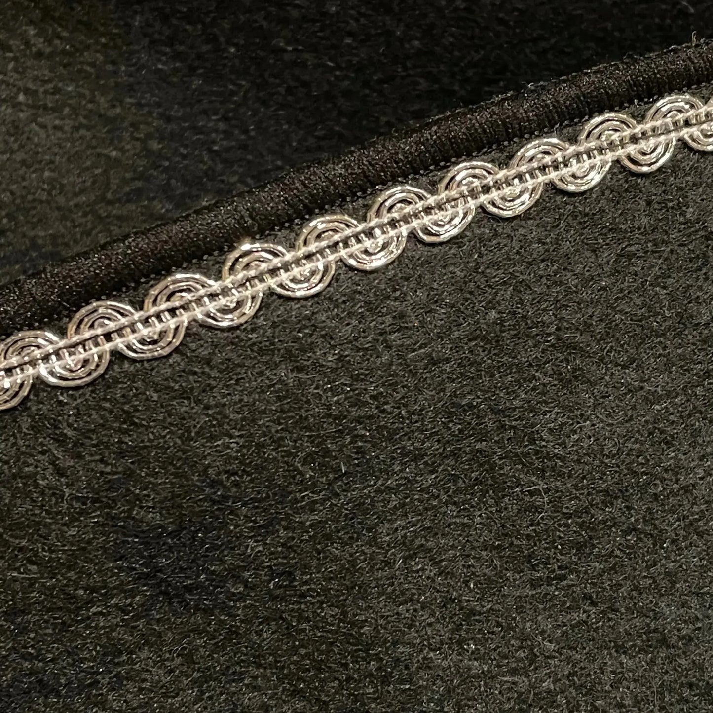Close-up of decorative trim on felt pirate hat for dress-up play